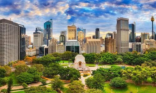 Aerial view of Sydney Hyde Park with CBD skyline in background and tress and grassy lawn of the park in the foreground