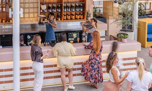 Bar staff and group of guests at the Harper Rooftop Bar