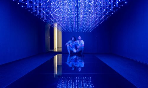 Two individuals observing light installation at the Tech Central White Rabbit Gallery