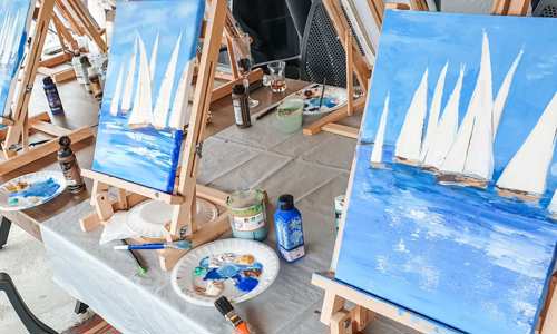 Painted canvas of boats at sea as part of a team and networking activity