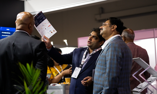 Three delegates in discussion on the expo floor at the Credai Natcon event