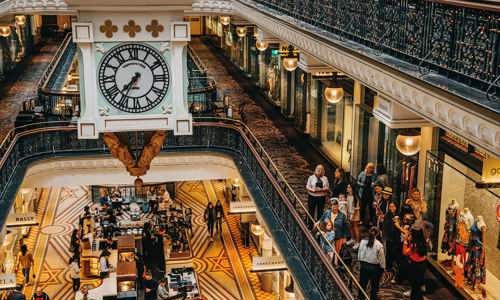 Small group admire the detailed interior of Queen Victoria Building during a guided architecture tour