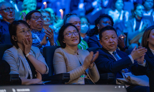 Group shot of ISPRM World Congress audience applauding presenter on stage