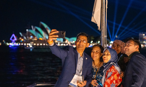 Conference attendees taking selfie on cruise boat