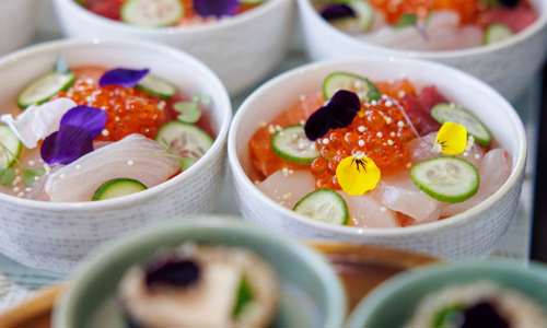 Natural food options fresh sashimi bowls with eatable flowers